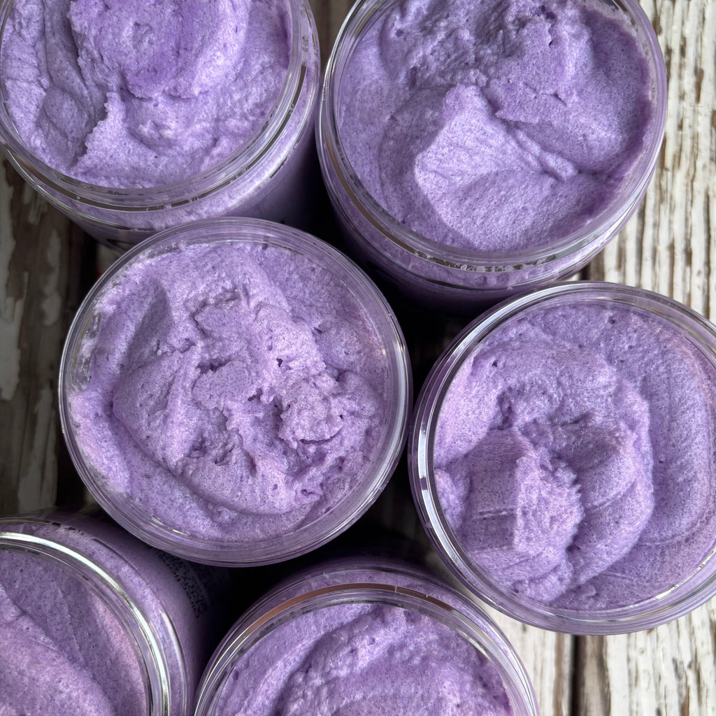 Jars of purple sugar scrub as viewed from the top with open lids