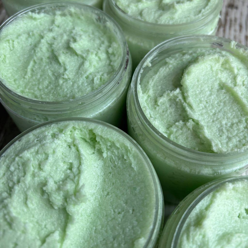 Jars of green sugar scrub with a textured surface.