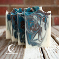 Marbled soap bars on a wooden surface with 'Moon Blossom Farm' branding.