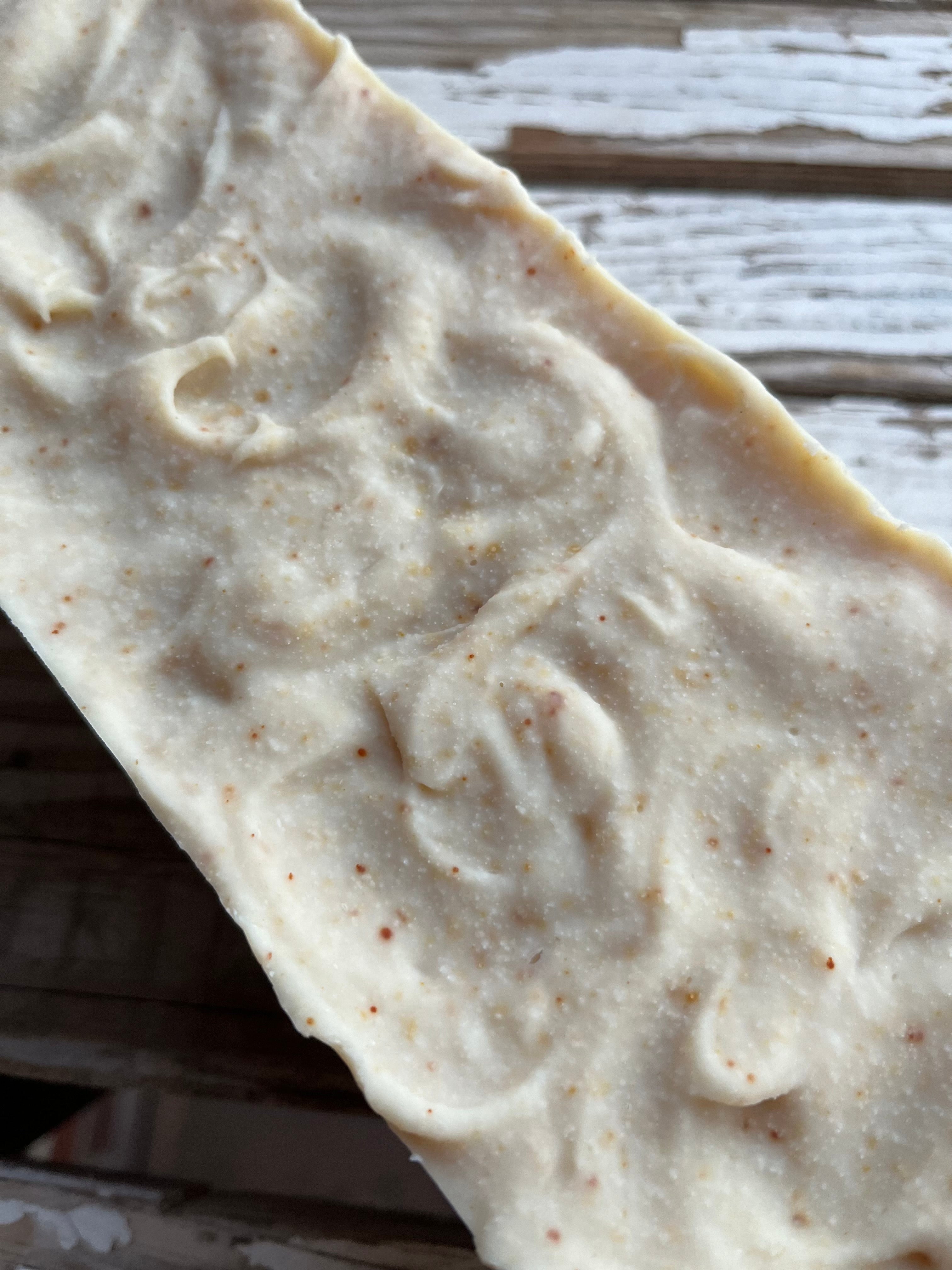 Close-up of a bar of soap with a textured surface on a wooden background