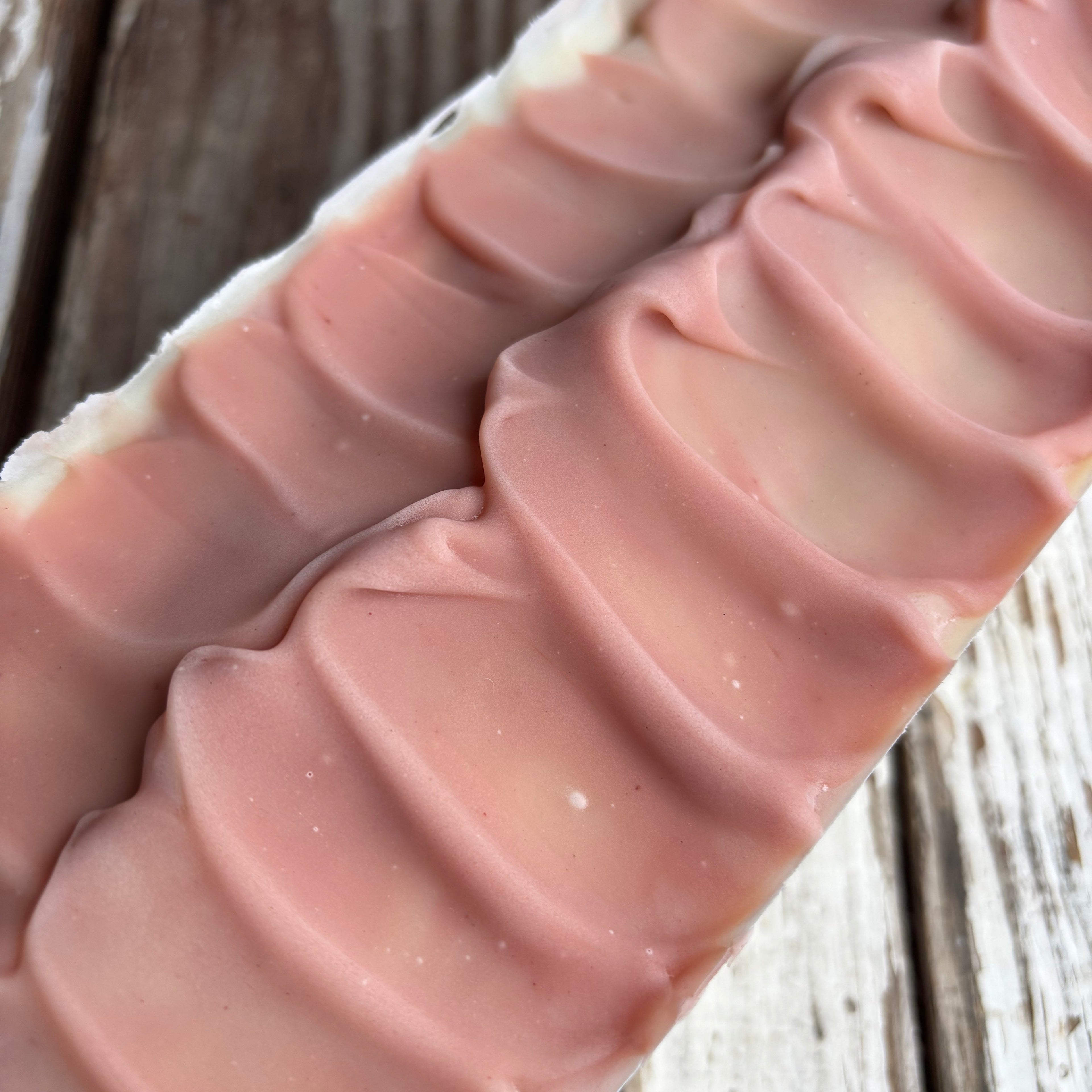 Top view of a pink soap loaf with textured top