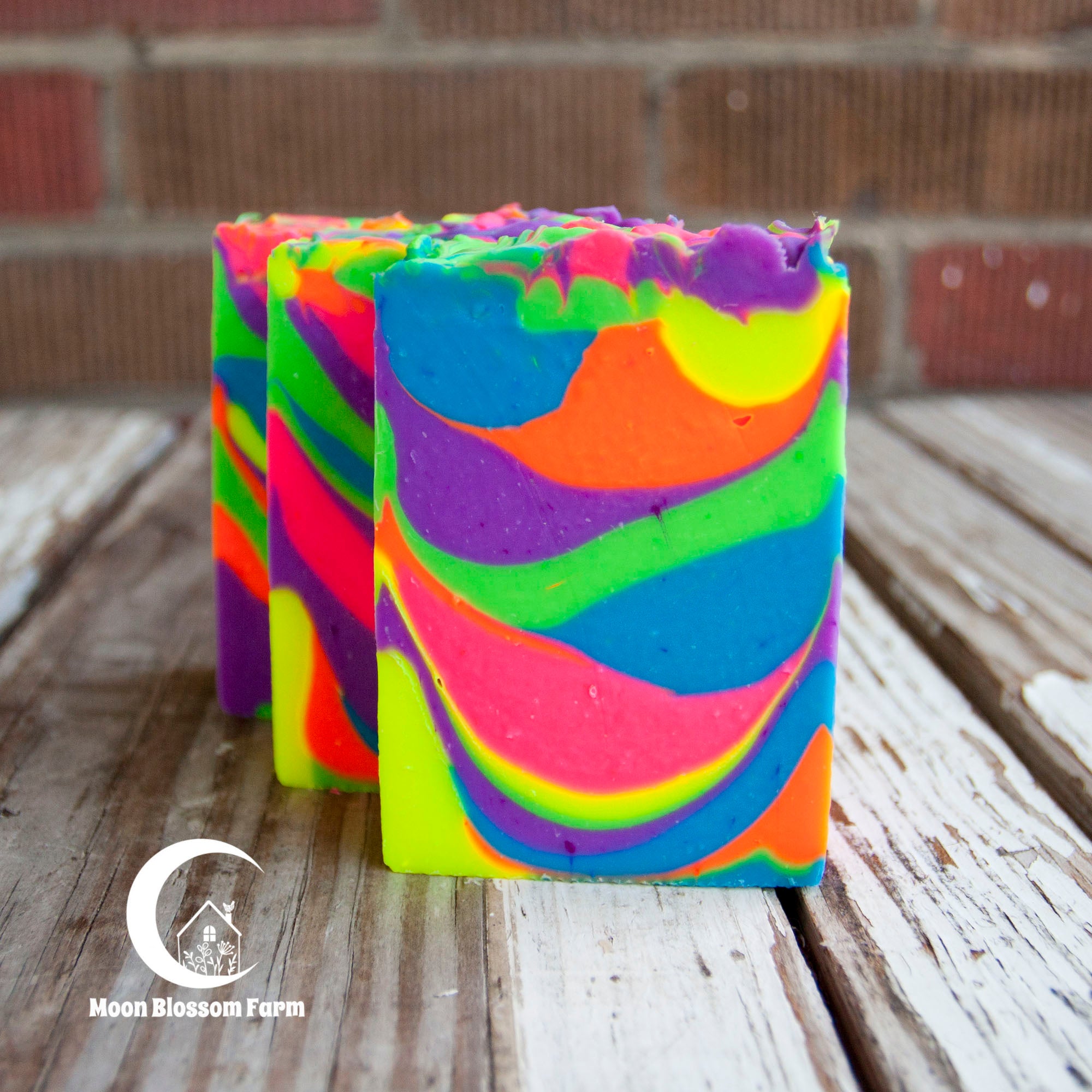 Colorful neon soap bars with a brick wall background
